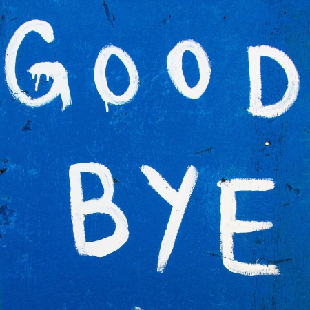 A handwritten sign that says 'Good Bye'. White paint on a dark blue background.