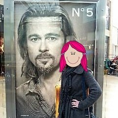 Me standing next to a giant street advert featuring Brad Pitt. My identity is hidden behind a cartoon face with pink hair.